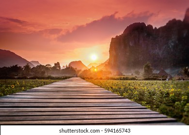 Wooden Footpath In A Field At Sunset. Mountain Landscape, Laos, Asia