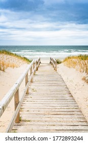 Wooden footpath on dune on Sylt. Entrance for the beach. North Germany.