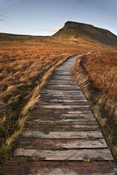 Wooden Footpath Over Marshland Leading To Pen-y-Ghent In Yorkshire Dales National Park