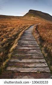 Wooden footpath over marshland leading to Pen-y-Ghent in Yorkshire Dales National Park