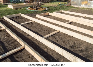 Wooden formwork from new boards for vegetable beds in the garden, preparation and construction, carpentry - Shutterstock ID 1752501467
