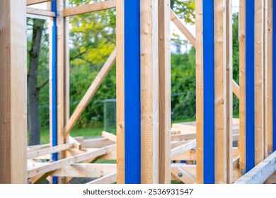 wooden frame beams commercial building in progress, construction elements, skeletal frame, building progress, raw materials, development project - Powered by Shutterstock