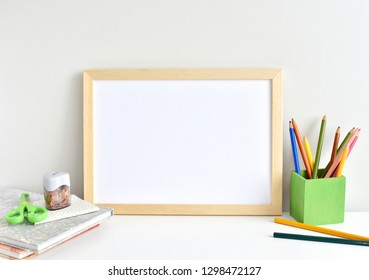 Wooden Frame Mockup, Kids Desk With Pencils And Books.