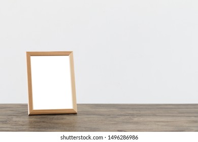 Wooden Frame On Wooden Table On White Background 