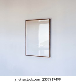 Wooden frame portrait on white wall. poster mockup a4, 50x70, 30x40. Scandinavian style wooden empty frame mockup for poster, social media, website, business, shop, advertisement.