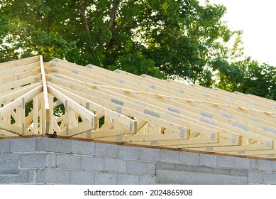 Wooden Frame Roof Construction For A New Domestic House. Residential House Construction Site. Development Of Small Construction