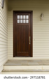 Wooden Front Door Of A Craftsman Style Home.