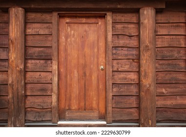 Wooden Front Door in to rustic cabin. Rustic log cabin with front door in the forest BC. Wooden wall with old door. Nobody, selective focus