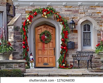 wooden front door with wreath and festive decorations
