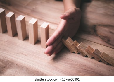 Wooden Game Strategy, Businessman Hand Stopping Risk Falling Wooden Dominoes Effect Create Stability For The Company