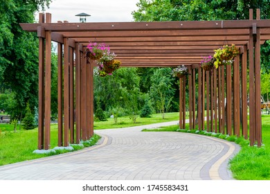 Wooden Garden Arch With Landscaping And Garden Street Flowers And Plants