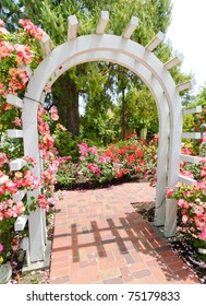 Wooden Garden Arch In A Pink Flower Garden