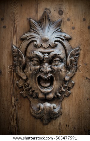 Wooden Gargoyle on old doors