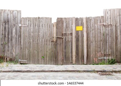 Wooden gate at a cobbled street/Wooden Fence and Gateway - Powered by Shutterstock