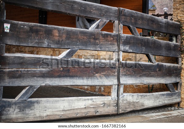 Wooden\
gate to the countryside. The fence on the farm. The construction of\
the boards. Check in for the car. Gate for\
cattle.