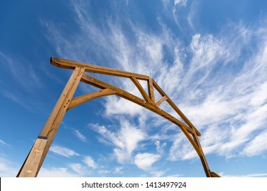 Wooden Gate Entrance To Ranch Against A Blue Sky