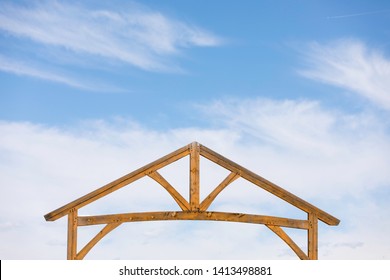 Wooden Gate Entrance To A Ranch Against A Blue Sky