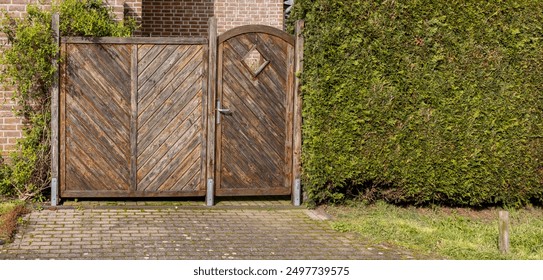 wooden gate with a wicket near green spaces as a fence
 - Powered by Shutterstock