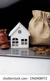 Wooden gavel, broken piggy bank and money bag. Real estate auction concept. Vertical image
