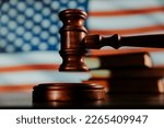 Wooden gavel and flag of United States of America. Law of USA concept.
