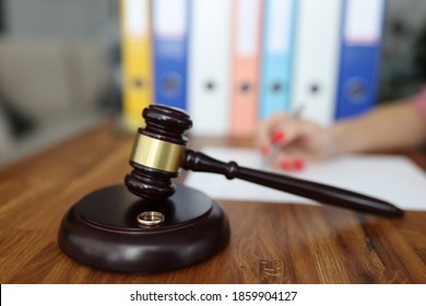 Wooden gavel for judge on stand is a wedding ring. Family divorce and division of property concept
