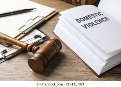 Wooden gavel and law book on wooden table. Protection from domestic violence - Shutterstock ID 2191217891