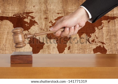Wooden gavel on a background map of the world