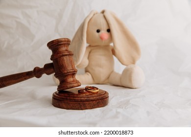 Wooden gavel and plush bunny. Law and children concept.