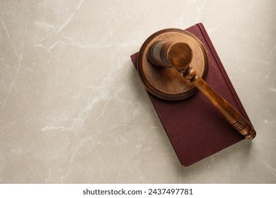 Wooden gavel, sound block and book on light textured table, top view. Space for text - Powered by Shutterstock