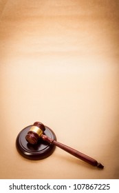 A Wooden Gavel And Soundboard On A Light Brown Background.