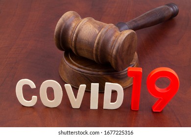 Wooden Gavel With Word Covid19. Laws And Decisions Against Covid-19.