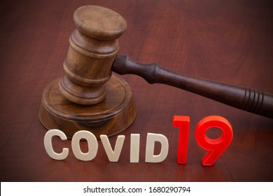 Wooden Gavel With Word Covid19. Laws And Decisions Against Covid-19.