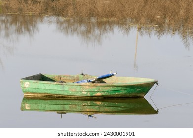 Wooden green colored fishing boat on the lake, reflection of the boat on the water. Authentic wooden boat. Sazlidere Lake, Istanbul, Turkey. - Powered by Shutterstock