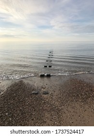 Wooden Groynes On A Beach In The British Seaside Coast