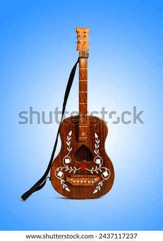 Wooden guitar toy on a blue glowing background