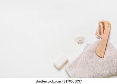 Wooden Hair Comb, Towel, Bar Soap And Pacifier On White Background, Closeup