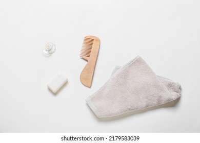 Wooden Hair Comb, Towel, Bar Soap And Pacifier On White Background