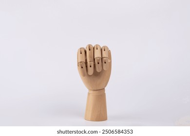 Wooden hand with clenched fist. Isolated on white background. Copy Space. Concept of symbol, gesture and sign - Powered by Shutterstock