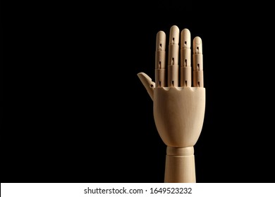 Wooden hand of mannequin for drawing shows five fingers on a black background. High five! Learning to count - five. Side view. Art model for drawing. Part of the body - hand, brush. 