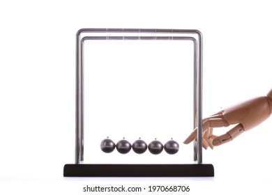 Wooden Hand Pushing A Set Of Newton Balls, Time Concept, Studio Photography