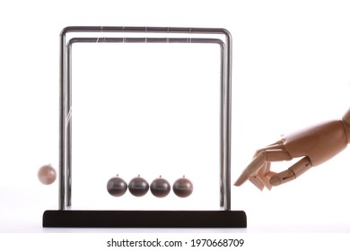 Wooden Hand Pushing A Set Of Newton Balls, Time Concept, Studio Photography