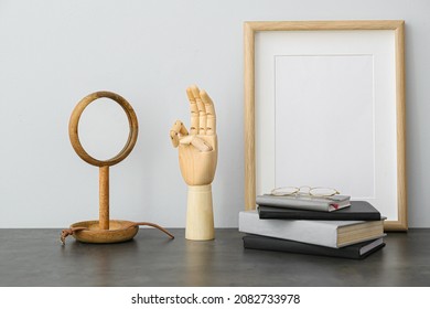 Wooden Hand Showing Letter W With Mirror On Table