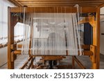  Wooden hand weaving machine. Weaving, traditional crafts, of a loom weaving, Woven silk,using cotton and silk string stretch and woven by using mechanic wooden machine to weave. Babadag Denizli.