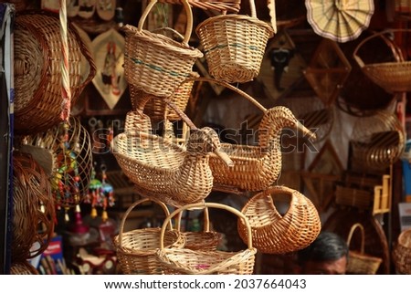 Wooden handicrafts (known as Jhalar in India) are hanging in a souvenir shop in Varanasi with copy space. Beautiful handicrafts are hanging in the shop with selective focus for sale. Indian market.
