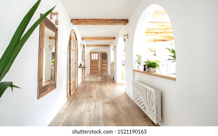 Wooden handmade mirror in hallway boho interior. Home indoors design concept.