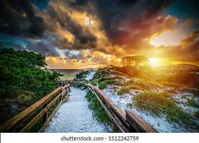 Wooden handrail in Maria Pia beach at sunset. Sardinia, Italy - Shutterstock ID 1512242759