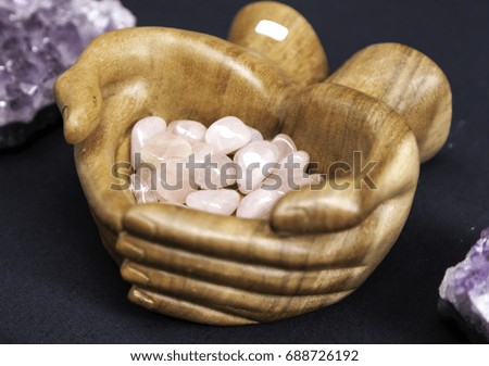 Wooden hands with jewels and pearls, crafts and fashion accessories