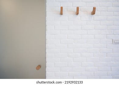 wooden hanger hook on white brick wall - Shutterstock ID 2192932133