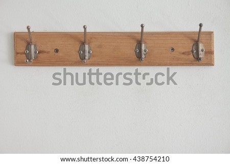 wooden hanger on white wall 