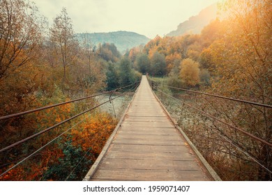 Wooden Hanging Rope Bridge Over Mountain River
